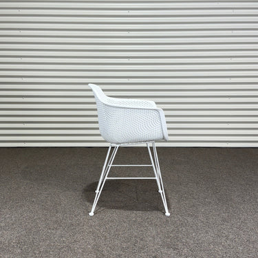 White chair against a corrugated metal wall