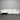 White sectional sofa against a corrugated metal wall.