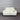 White leather sofa against a gray corrugated metal wall.