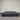 Charcoal fabric, bed base, made in New Zealand, pine wood, corner guard protection, on a gray floor with a striped wall background