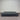 Charcoal fabric, bed base, made in New Zealand, pine wood, corner guard protection, on a gray floor with a striped wall background