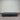 Charcoal fabric, bed base, made in New Zealand, pine wood, corner guard protection, on a gray floor with a striped wall background