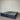 Charcoal fabric, bed base, made in New Zealand, pine wood, corner guard protection, on a gray floor with a striped wall background