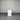 White cabinet with a beige top against a corrugated metal wall.
