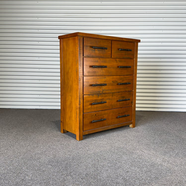 Wooden dresser with multiple drawers against a corrugated metal wall - wanaka collection