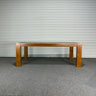 Wooden table against a corrugated metal wall