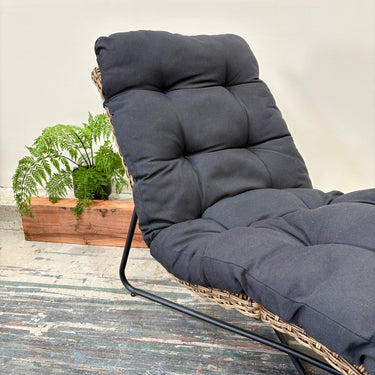 Side profile of Dario Outdoor Sunlounge showing ergonomic wave design and wicker frame