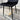 Tapered black metal legs of modern dining chair, close view