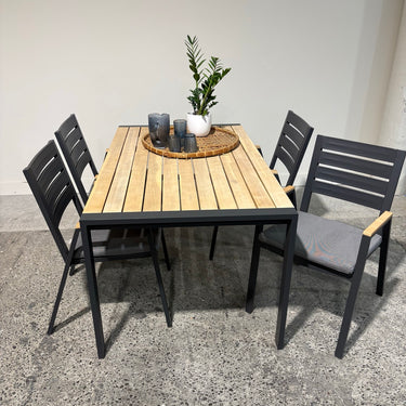 Kartini Outdoor Dining Set side angle showing table and four chairs with light-grey cushions