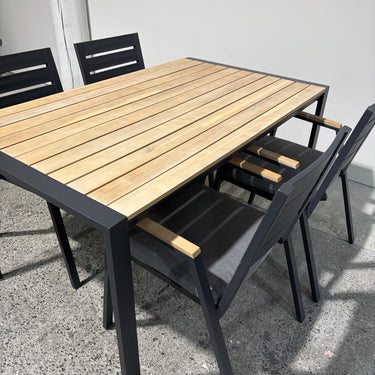 Close-up of Kartini table showing natural timber-look slats and anodised aluminium frame detail.
