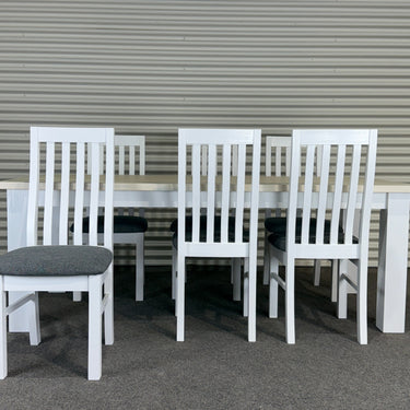 White outdoor furniture set on a gray surface