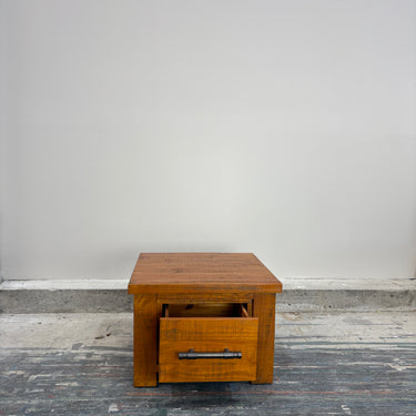 Wanaka Lamp Table with drawer open showing storage space, chestnut pine finish – Direct Furniture Outlet NZ.