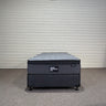 Workhorse LUX king single mattress with matching base, front view showing grey quilted top, dark upholstered base and Hotel Mattress Co label against corrugated wall.